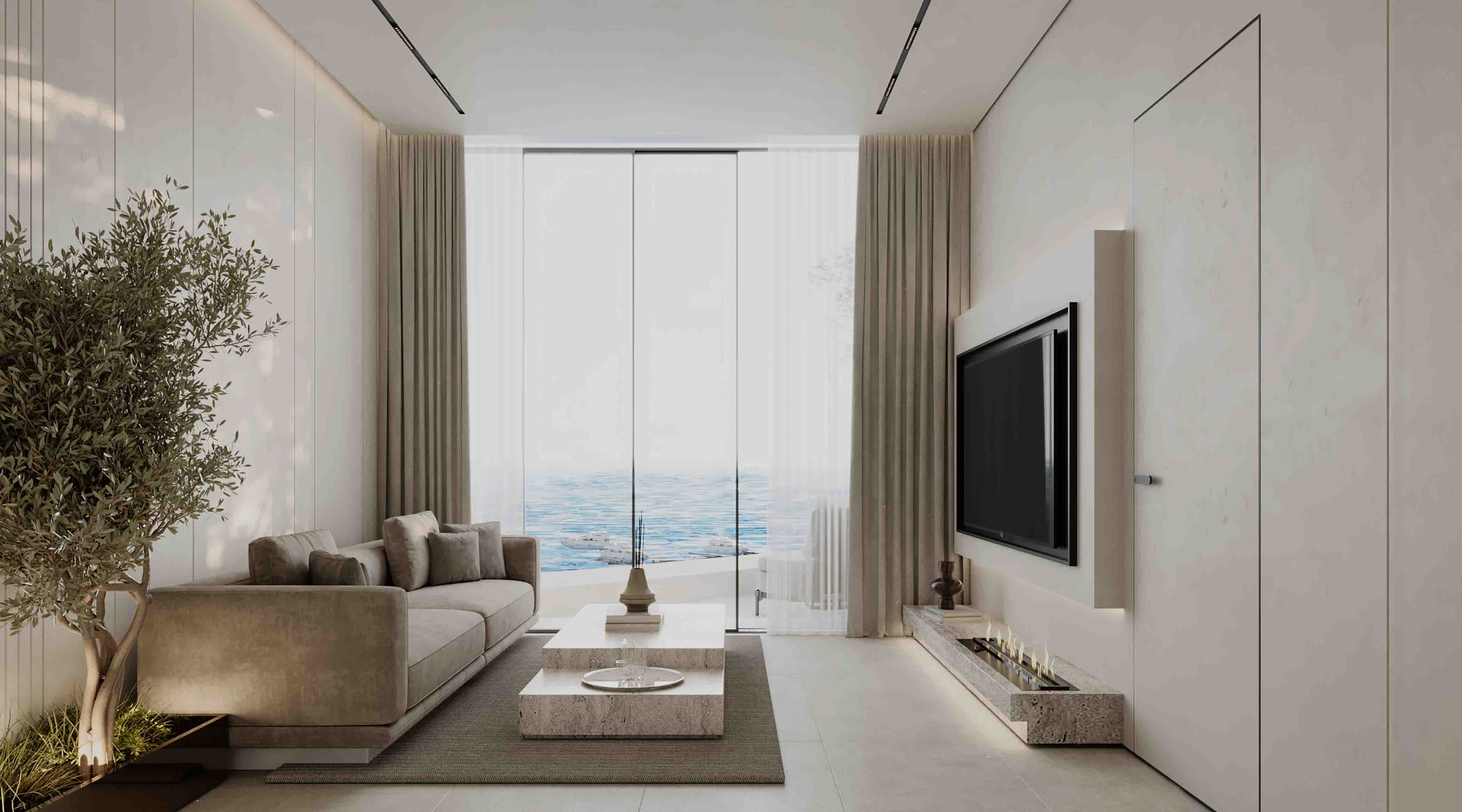 Elegant living room with large sofa, minimalist coffee table and full-height windows overlooking the ocean.