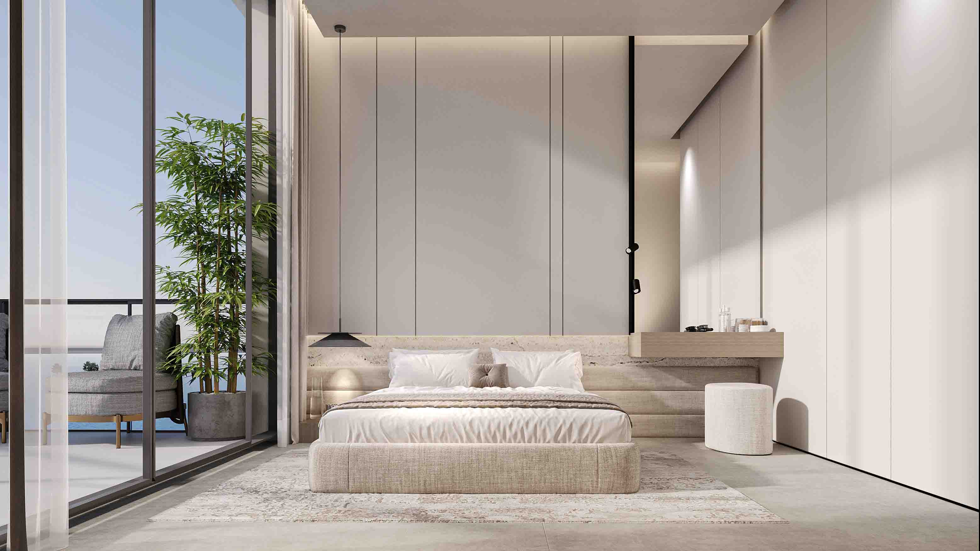 Bright bedroom with soft neutral tones, large bed and balcony lounge overlooking the sea.