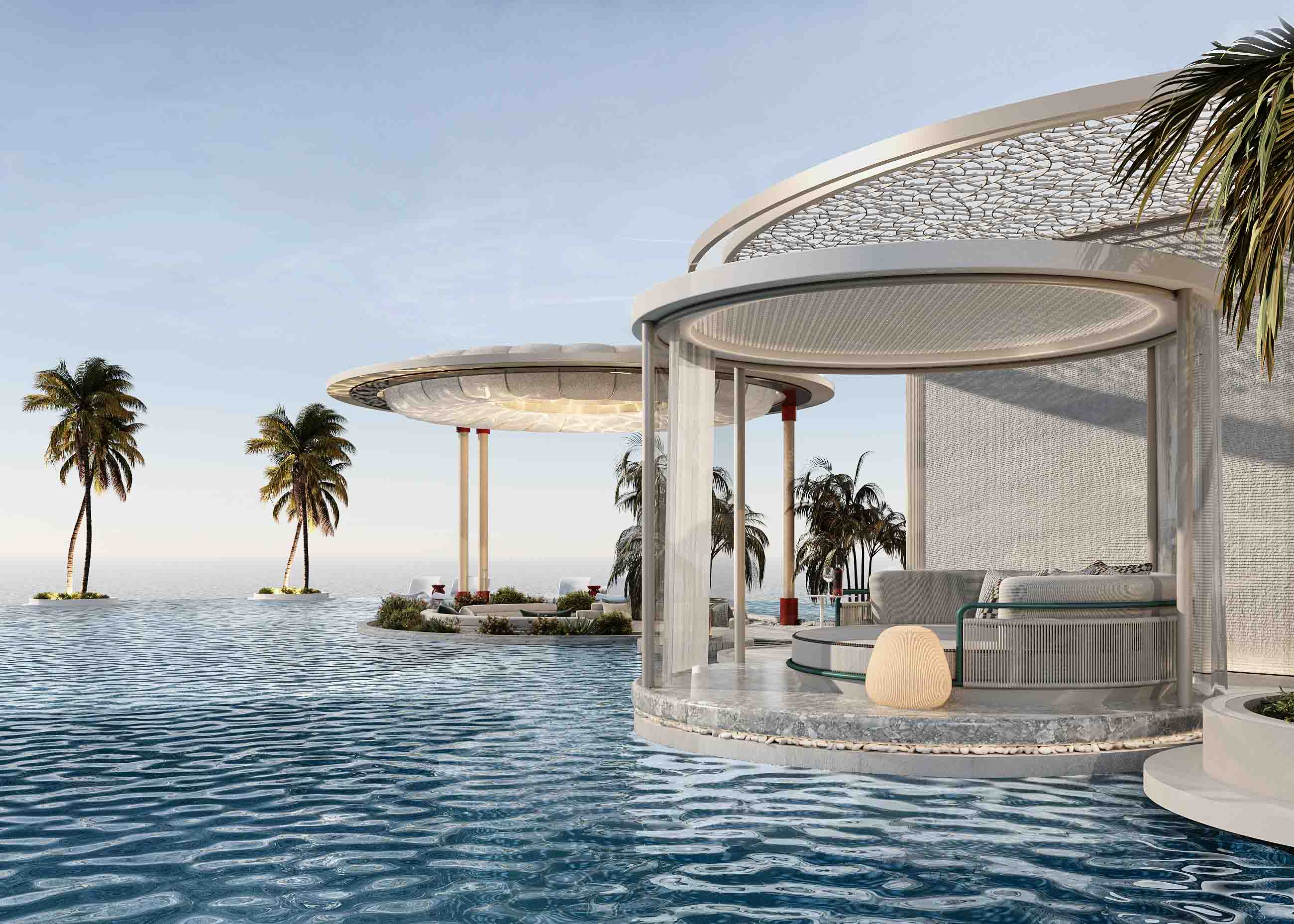 Rooftop infinity pool with circular cabana pavilions and open sea views surrounded by palm trees.