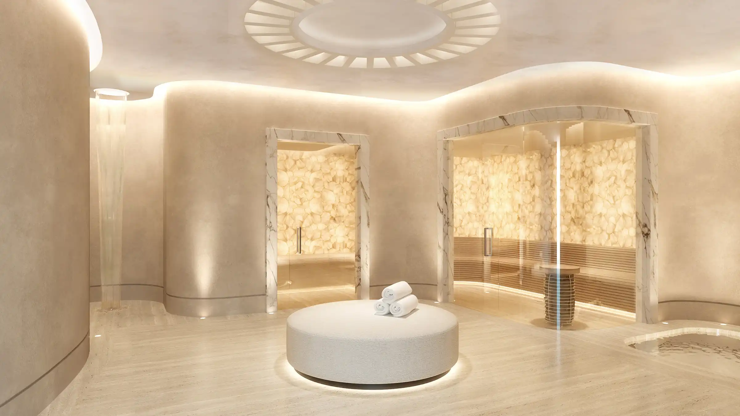 A circular harmony lounge featuring cascading water walls and elegant beige interiors.