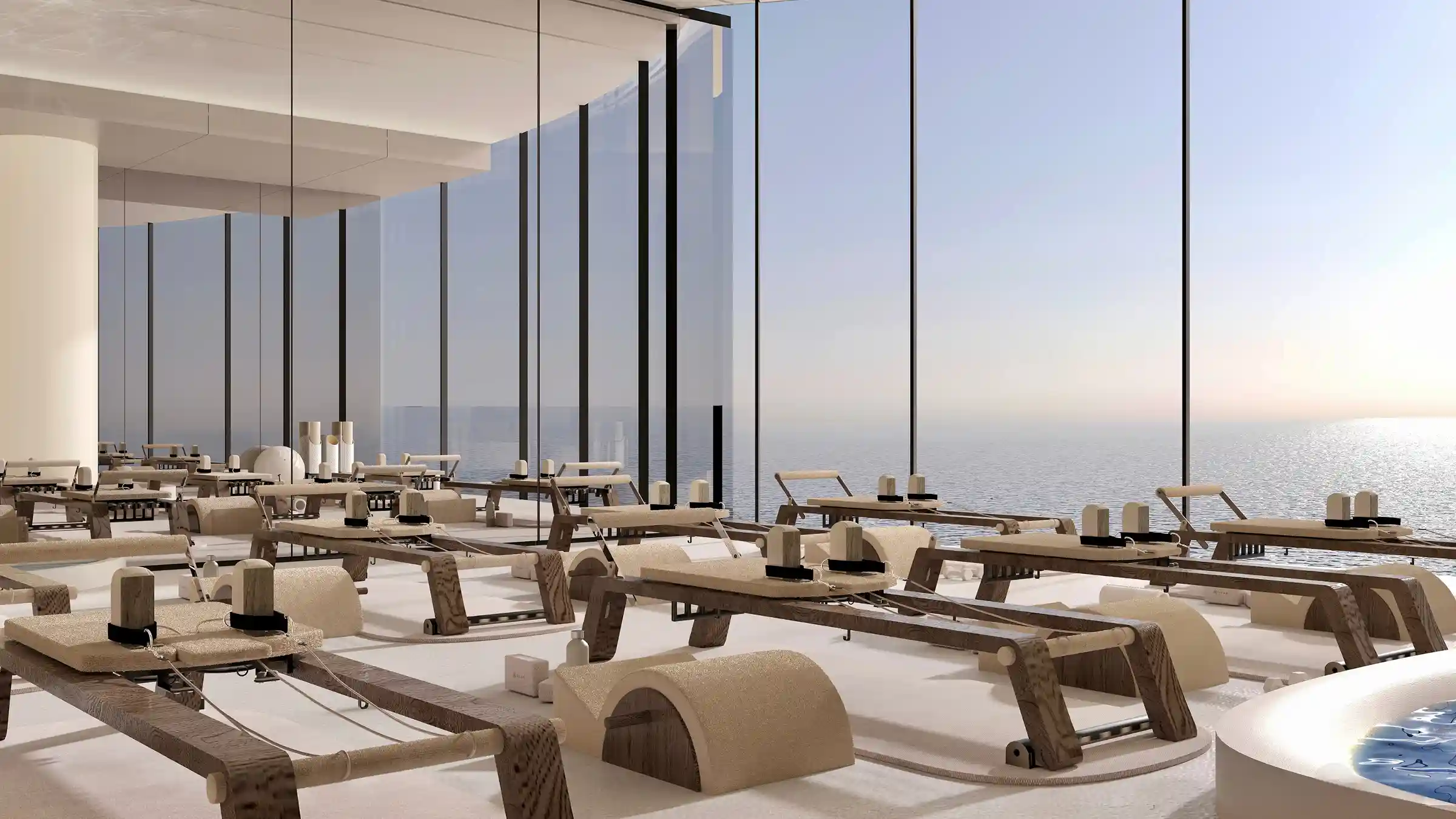 A serene Pilates and reformer studio bathed in natural light, overlooking the open sea for a calming workout experience.